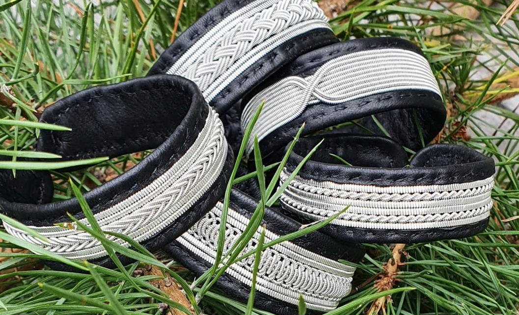 Pewter bracelets lying on green grass